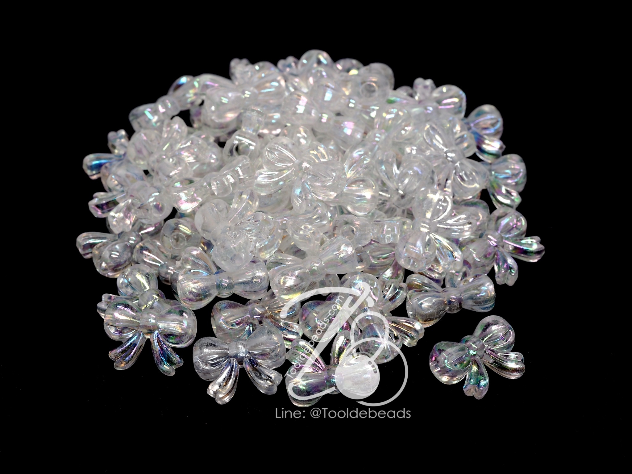ลูกปัดพลาสติก เคลือบรุ้ง 12*20มม. ลายโบว์อ้วน สีขาวรุ้งใส (100 กรัม) SKU-09571